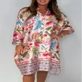 Detailed view of a pink women's dress with vibrant tropical floral and leaf patterns. - XS / Dresses / Pink