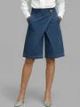 Detail view of women's asymmetrical high-waisted denim-look shorts on model - S / Bottoms / Dark Blue
