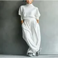 Close-up detail of white loose turtleneck sweater and wide-leg jogger pants set for women - S / Top And Bottom / White