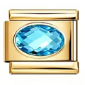 Close-up macro view of a gold stainless steel Italian charm link with blue oval zircon - Light Blue Zirconia Link