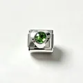 Close-up of a stainless steel heart charm link with a green faceted zircon stone. - Green Zirconia (#12)