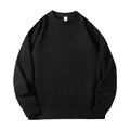 Detailed view of a loose-fitting black crewneck sweatshirt with ribbed cuffs and hem. - S / Tops / Black