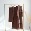 Élégant ensemble deux pièces en mousseline marron avec écharpe sur un portant doré - S / Ensemble / Café