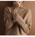 Macro view of the diamond pattern and soft knit texture on a brown turtleneck sweater. - Dark Brown