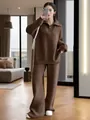 Full-body view of a model in a brown half-zip knitted sweater and wide-leg pants set - Dark Brown