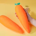 Handheld view of a giant carrot-shaped soft squishy toy for stress relief and sensory play - Jumbo Carrot / Orange