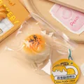 Jouet antistress mignon en forme de gâteau au jaune d'œuf dans un sac transparent - Pâtisserie au jaune d'œuf