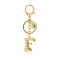 Close-up of a golden bubble letter F keychain with heart charm and lobster clasp - Letter F