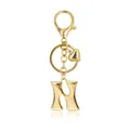 Detail of a polished gold bubble letter H keychain featuring a small heart charm and clasp - Letter N