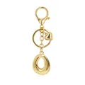 Detailed macro shot of golden letter O alphabet keychain featuring heart charm and lobster clasp - Letter O