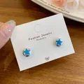 Elegant blue star-shaped stud earrings displayed on a white fashion jewelry card - Blue Star Cat's Eye Stone Style (XXW001)