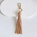 Detailed view of peach leather tassel charm with golden lobster clasp and ring - Tassel Style / 10cm / Khaki