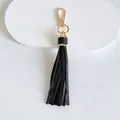 Close-up detail of a premium 10cm black leather tassel with elegant gold metal clasp - Tassel Style / 10cm / Black