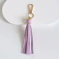 Detailed view of a light purple leather tassel keychain with gold-plated metal clasp - Tassel Style / 10cm / Purple