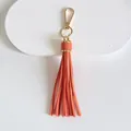 Detailed view of 10cm bright orange leather tassel keychain charm with gold lobster clasp - Tassel Style / 10cm / Orange