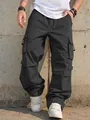 Detail showing texture and large functional pockets of dark grey parachute cargo pants - S / Bottoms / Black