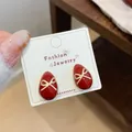 Elegant festive cherry red teardrop stud earrings featuring a delicate gold bow detail - Red Bow Tie Waterdrop Earring (JHW013)