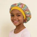 Close-up of a child wearing a colorful holographic sleep bonnet with a yellow elastic band - One Size / Yellow