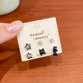 Cute asymmetric black cat and silver star stud earrings set displayed on a card - Zirconia Star Cat Collection (MMT38)