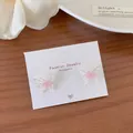 Elegant silver butterfly stud earrings with pink rose center detail on display card - Dream Butterfly Flower (QM3)