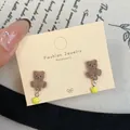 Charming brown flocked bear stud earrings with cute yellow star charms on a display card - Sitting Bear With Star (VF14) / Brown