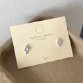 Cute minimalist silver ice cream cone shaped stud earrings on a beige display card - Ice Cream (WE4)