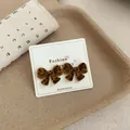 Stylish leopard print flocked bow stud earrings displayed on a white fashion card - Leopard Bowknot (BWW22)