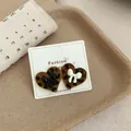 Elegant leopard print flocked heart-shaped stud earrings with bow accent for women - Black and White Heart Leopard