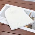 Detail view of a soft white ribbed knit beanie hat for winter warmth and style. - High Elasticity / White