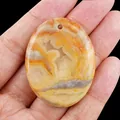 Natural orange and yellow banded agate oval palm stone pendant for jewelry making - Crazy Agate