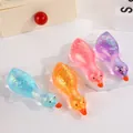 Close-up of four colorful glittery duck squishy toys with a cute translucent texture - OPP Bag / Gold Powder Roast Duck