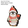 Handcrafted wooden penguin Christmas ornament holding heart for holiday table decor - Penguin