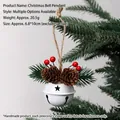 White Christmas bell ornament with pine cones and berries hanging on tree branch - White