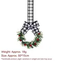 Traditional Christmas wreath ornament featuring a buffalo check bow and red berries - Black and White Plaid Style