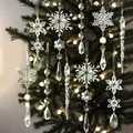 Detail view of various clear acrylic snowflake and icicle ornaments hanging on a Christmas tree - 18 Pieces/Pack / Clear