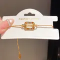 Detailed view of the 18K gold-plated bracelet with multi-color cubic zirconia. - Multicolor Geometric / Gold