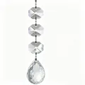 Close-up of transparent faceted octagonal beads and a teardrop crystal pendant hanging - Teardrop Pendant