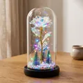 Luminous iridescent rose in glass dome with mini Christmas trees and LED string lights. - Plastic Dome + Color Box / Galaxy Gold with Multicolor Light and Black Base