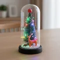 Mini árbol de Navidad luminoso en cúpula de vidrio con adorno de reno SKU - Reno (Base Negra) / Cúpula de plástico / Luz Colorida