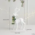 Elegante weiß beflockte Weihnachtsrentier-Figur mit grüner Schleife und Glocken, 34cm - Rentier mit erhobenem Kopf