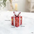 Luminous red metal Christmas gift box ornament with star cutouts on snow background - Red Iron Glowing Gift Box