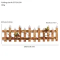 Rustic wooden Christmas tree fence with artificial snow and red berry decorative accents - Natural House Style