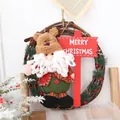 Handmade rustic Christmas rattan wreath featuring plush Santa Claus with reindeer hat - Santa Holding Sign