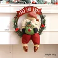 Handcrafted Christmas Santa Claus grapevine wreath with HO HO HO banner for wall decor - Green Dangling Leg Santa