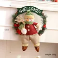 Festive Christmas snowman wreath hanging decor with welcome sign and pine needle accents - Green Dangling Leg Snowman