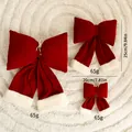 Three burgundy velvet Christmas bows in different sizes displayed on a white rug - Set of 3 / Bow