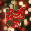 Detailed view of a red Ohio state shaped Christmas ornament with gold Merry Christmas text. - Ohio