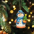 Close-up of a cute snowman Christmas ornament hanging on a festive pine tree with lights - Christmas Snowman Style (0)