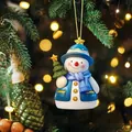 Close-up of a blue and white snowman ornament hanging among warm Christmas tree lights - Christmas Snowman Style (3)