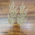 Close-up view of two gold artificial pine branches for DIY Christmas tree floral decor - Pine and Cypress Leaves / 35cm / Champagne
